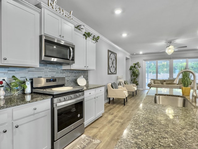 209 Celestial Blvd, Summerville, SC 29486 - kitchen with appliances with stainless steel finishes, a sink, crown molding, open floor plan, and decorative backsplash
