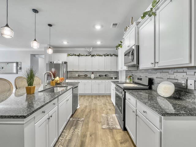 209 Celestial Blvd, Summerville, SC 29486 - kitchen featuring appliances with stainless steel finishes, a sink, white cabinetry, decorative backsplash, and crown molding