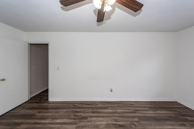 empty room with ceiling fan, dark wood-type flooring, and a textured ceiling