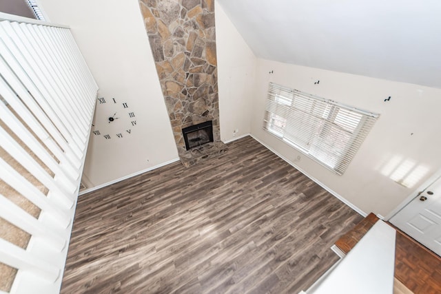 living room with lofted ceiling, a fireplace, and dark hardwood / wood-style floors