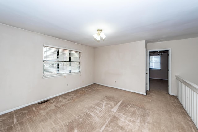 spare room featuring light colored carpet