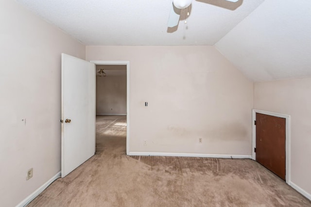 bonus room featuring light carpet, a textured ceiling, vaulted ceiling, and ceiling fan