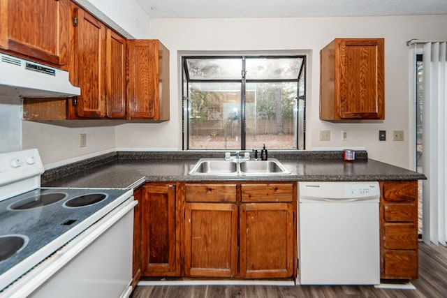 kitchen featuring a textured ceiling, dark hardwood / wood-style floors, white appliances, and sink