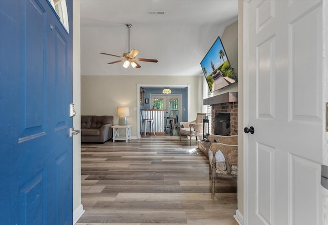5052 Hidden Forest Ln, North Charleston, SC 29420 - entrance foyer with ceiling fan, wood finished floors, a brick fireplace, vaulted ceiling, and french doors