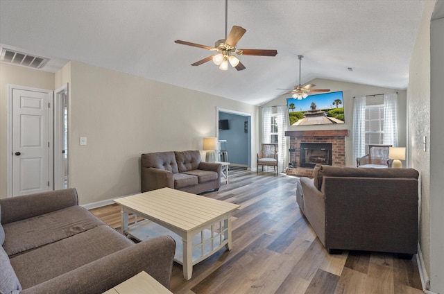 5052 Hidden Forest Ln, North Charleston, SC 29420 - living area with a ceiling fan, vaulted ceiling, light wood-type flooring, and a fireplace