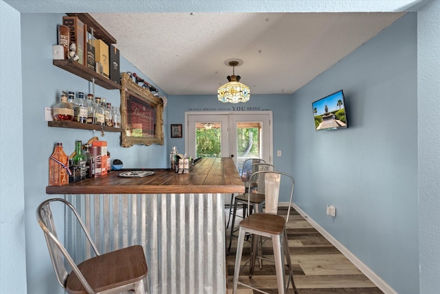 5052 Hidden Forest Ln, North Charleston, SC 29420 - indoor dry bar with wood finished floors, french doors, and a textured ceiling