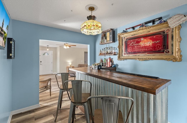 5052 Hidden Forest Ln, North Charleston, SC 29420 - indoor dry bar featuring wood finished floors, ceiling fan, and pendant lighting