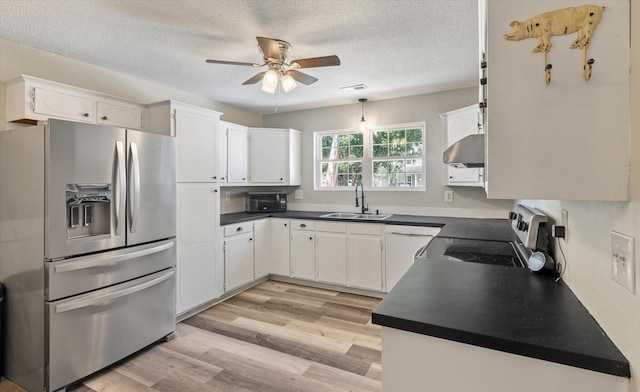 5052 Hidden Forest Ln, North Charleston, SC 29420 - kitchen featuring appliances with stainless steel finishes, ventilation hood, ceiling fan, dark countertops, and a textured ceiling