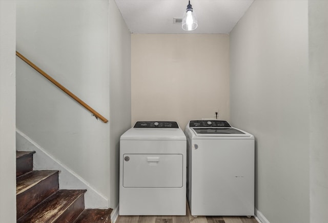 5052 Hidden Forest Ln, North Charleston, SC 29420 - laundry area featuring washing machine and clothes dryer and wood finished floors