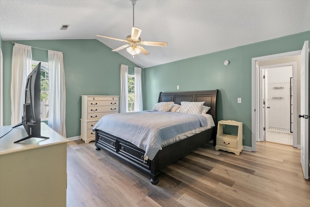 5052 Hidden Forest Ln, North Charleston, SC 29420 - bedroom with multiple windows, light wood-style floors, vaulted ceiling, and a ceiling fan