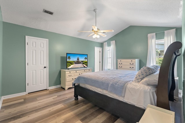 5052 Hidden Forest Ln, North Charleston, SC 29420 - bedroom featuring light wood finished floors, vaulted ceiling, ceiling fan, and a textured ceiling