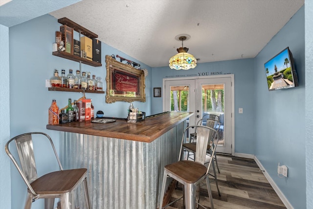 5052 Hidden Forest Ln, North Charleston, SC 29420 - indoor dry bar with wood finished floors, a textured ceiling, and french doors