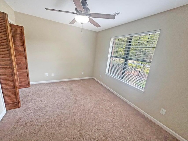 spare room featuring light colored carpet