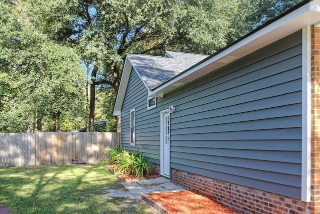 view of property exterior with a lawn