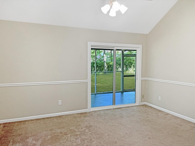 empty room featuring carpet floors and vaulted ceiling