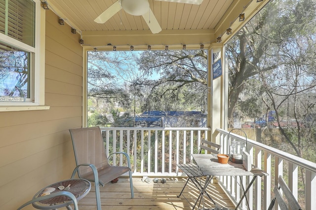 sunroom / solarium featuring wooden ceiling and a ceiling fan