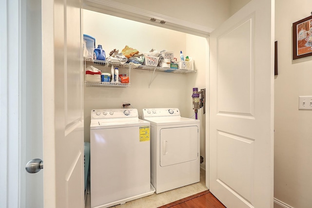 washroom with laundry area, independent washer and dryer, and wood finished floors