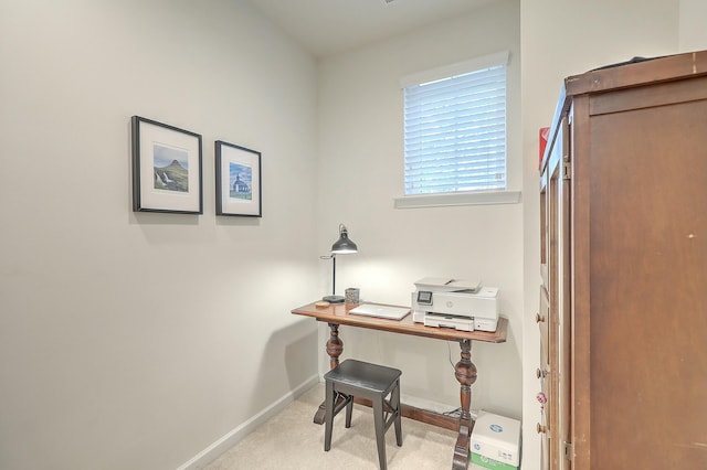 carpeted office space featuring baseboards