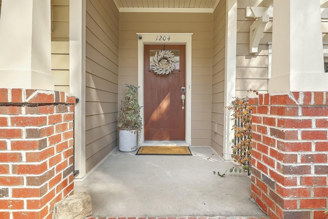 doorway to property with brick siding