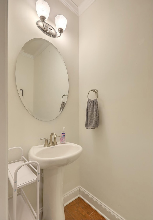 bathroom featuring wood finished floors, baseboards, and ornamental molding