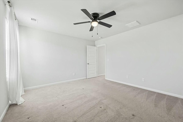 empty room with ceiling fan and light colored carpet