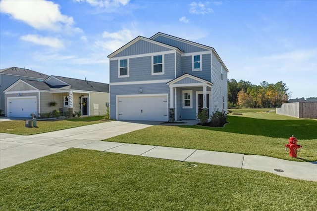 view of front of property with a front yard and a garage