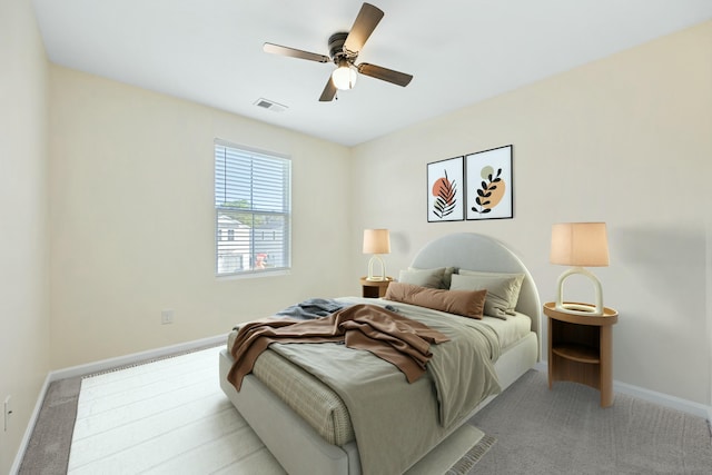 bedroom featuring ceiling fan and light carpet