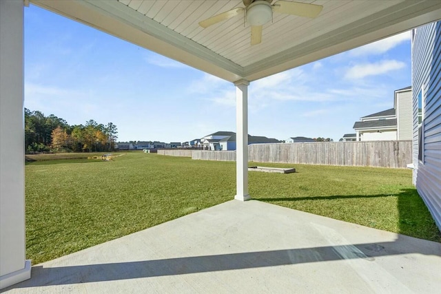 view of yard with ceiling fan and a patio