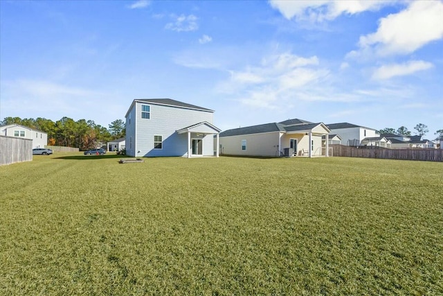 rear view of house with a yard