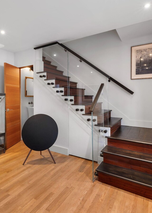 301 Broad St Unit 1, Charleston, SC 29401 - stairs with wood finished floors and recessed lighting