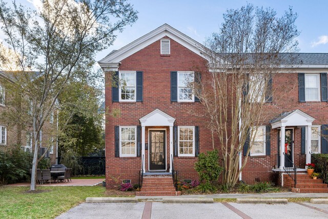 301 Broad St Unit 1, Charleston, SC 29401 - view of property featuring entry steps, brick siding, and uncovered parking