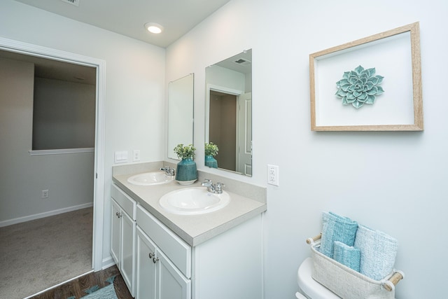 101 Orchid Bloom Cir, Moncks Corner, SC 29461 - bathroom with double vanity, toilet, baseboards, and wood finished floors