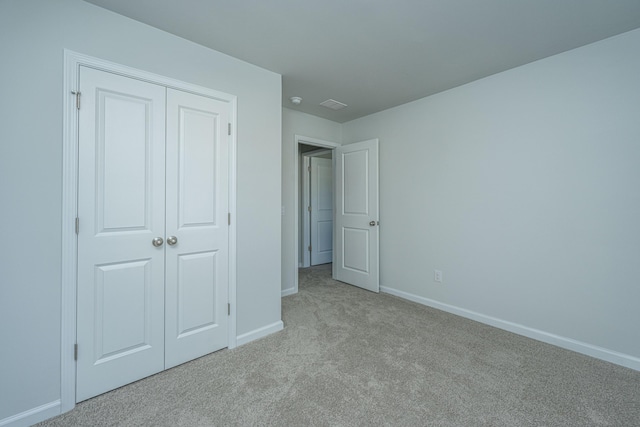 101 Orchid Bloom Cir, Moncks Corner, SC 29461 - unfurnished bedroom with light carpet, baseboards, and a closet