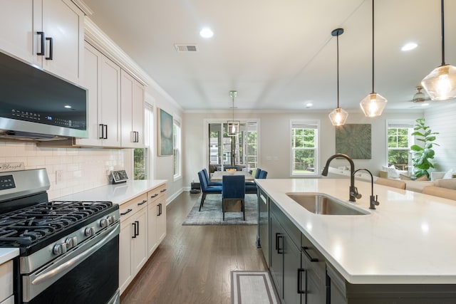125 Beam St, Huger, SC 29450 - kitchen with appliances with stainless steel finishes, a sink, open floor plan, light countertops, and dark wood finished floors