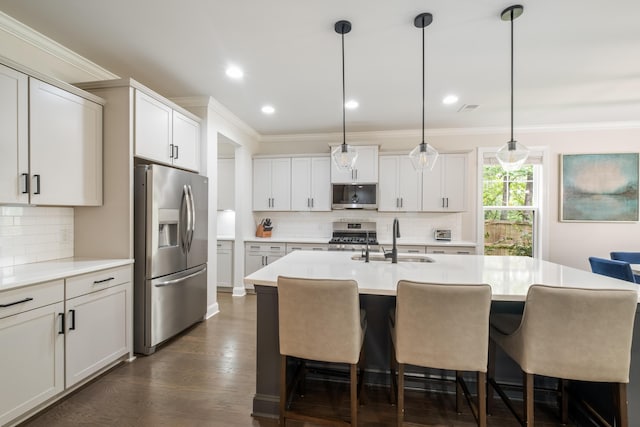 125 Beam St, Huger, SC 29450 - kitchen featuring stainless steel appliances, a sink, backsplash, a breakfast bar, and ornamental molding