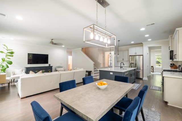125 Beam St, Huger, SC 29450 - dining room featuring recessed lighting, ornamental molding, ceiling fan, dark wood-style flooring, and stairway