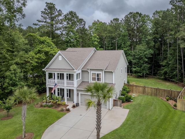 125 Beam St, Huger, SC 29450 - view of front of house featuring concrete driveway, a garage, a shingled roof, a balcony, and a porch