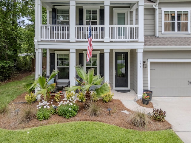 125 Beam St, Huger, SC 29450 - view of front of house featuring a balcony, covered porch, a garage, a shingled roof, and driveway