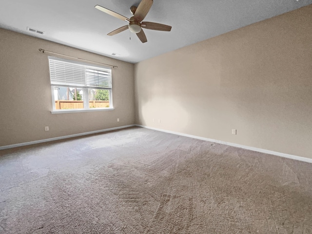 unfurnished room featuring ceiling fan and carpet floors