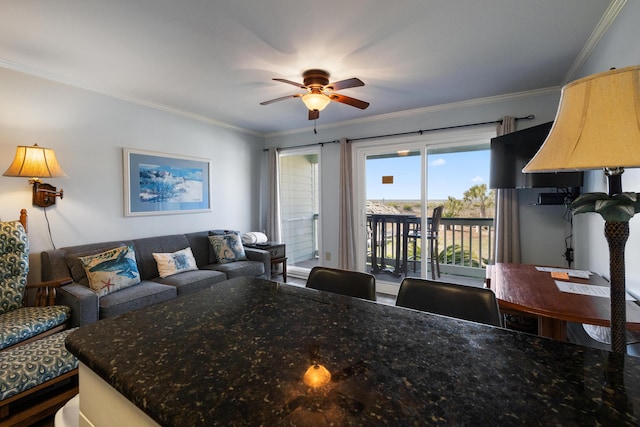 living area featuring crown molding and ceiling fan