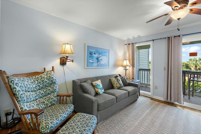 living room with ceiling fan, crown molding, and wood finished floors