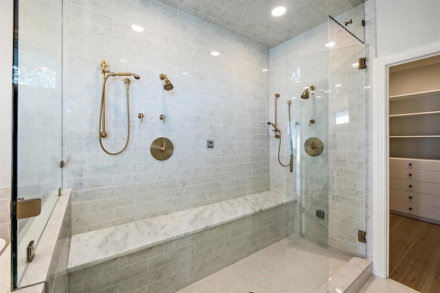 bathroom featuring wood-type flooring and a shower with shower door