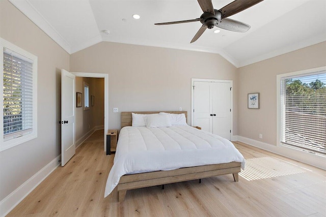 bedroom featuring ceiling fan, lofted ceiling, and light hardwood / wood-style flooring