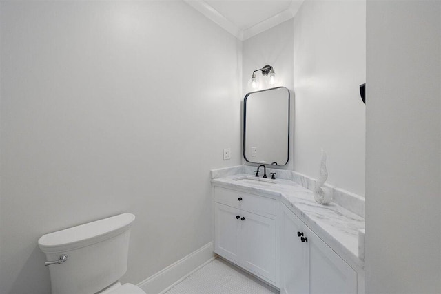 bathroom with tile patterned flooring, vanity, ornamental molding, and toilet