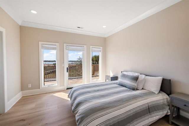 bedroom with crown molding, light hardwood / wood-style flooring, and access to outside