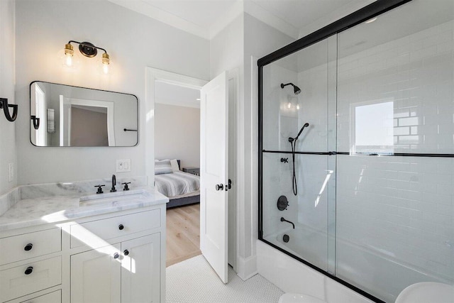 bathroom featuring ornamental molding, shower / bath combination with glass door, tile patterned flooring, and vanity