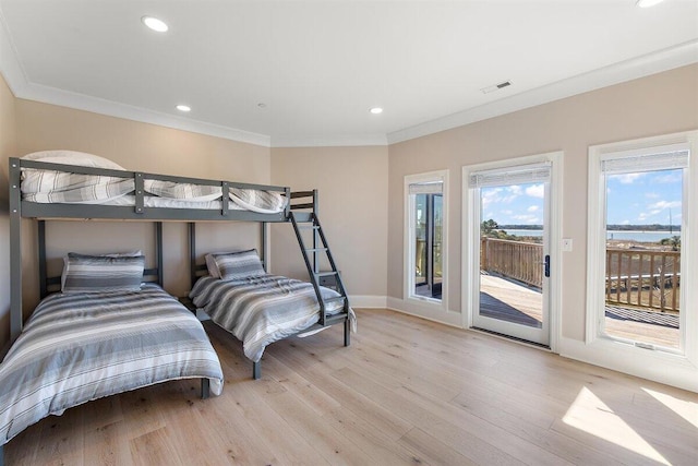 bedroom with access to exterior, crown molding, and light wood-type flooring