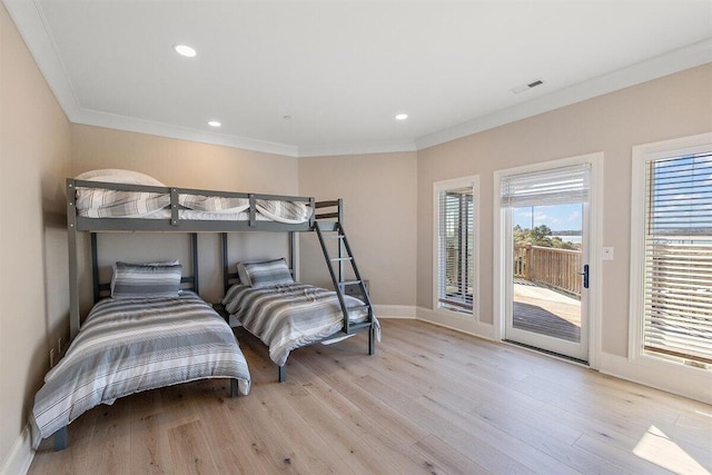 bedroom with crown molding, access to exterior, and light wood-type flooring