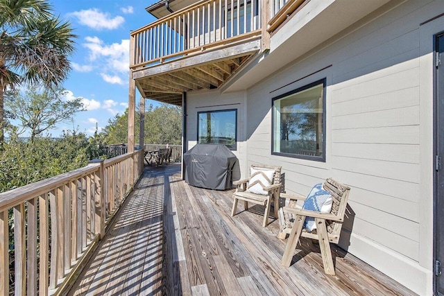 wooden terrace featuring area for grilling