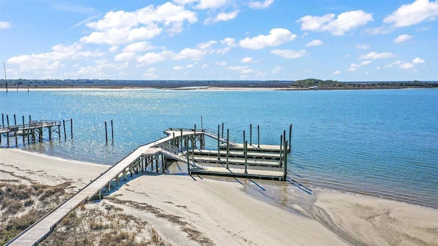 dock area featuring a water view and a view of the beach